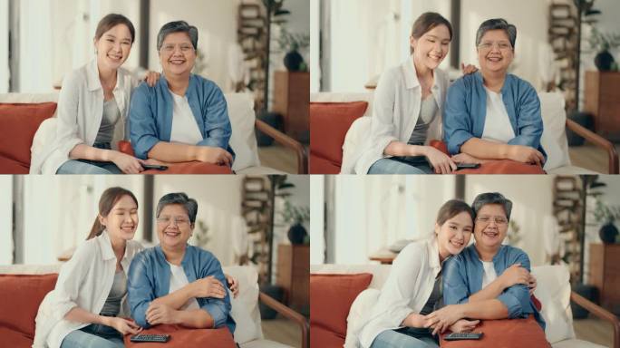 亲密的关系:亚洲老年妇女和女儿全神贯注于电视节目，分享笑声和积极的情绪在家里