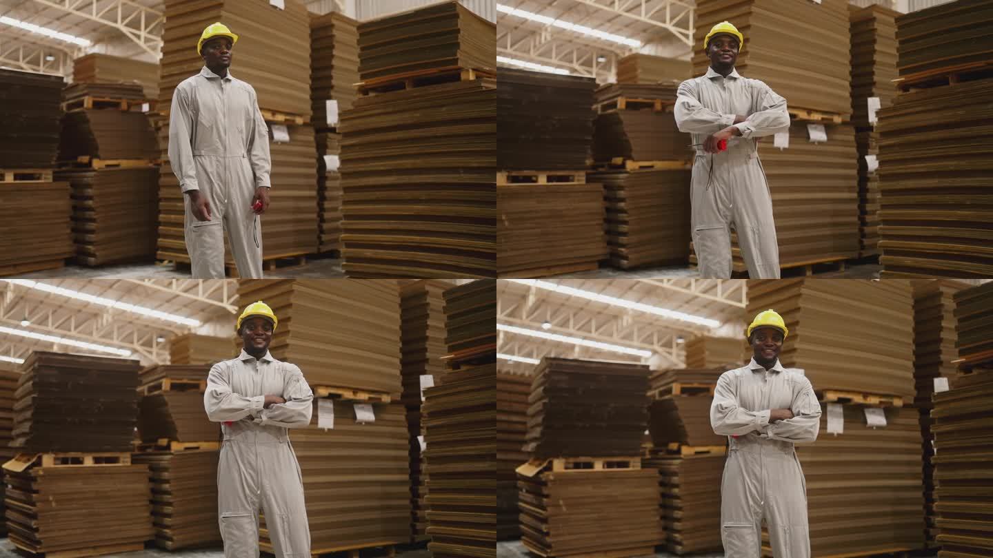 黑人男工程师在制造厂纸板造纸厂视察的肖像。
