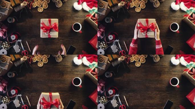俯视图手拿圣诞礼物在木桌从上面-红色史诗龙