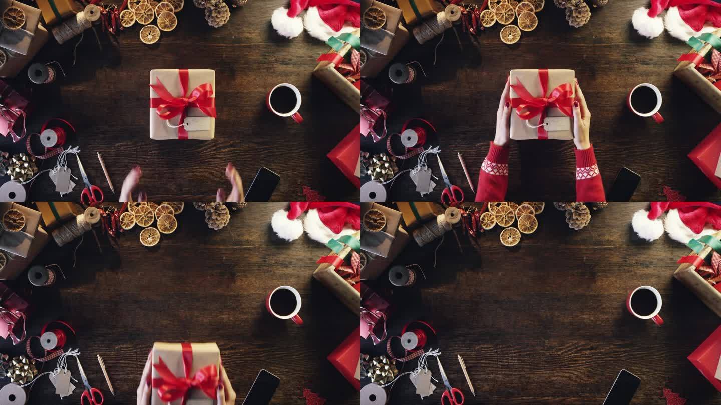 俯视图手拿圣诞礼物在木桌从上面-红色史诗龙
