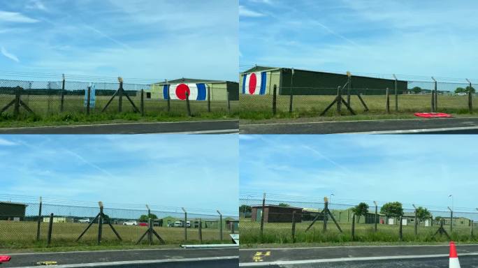 从移动的汽车上看到铁丝网后面的英国皇家空军机场