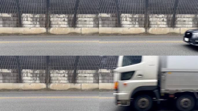 繁忙的城市街道:汽车从侧面通过的视角库存视频，隔音屏障