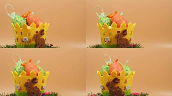 复活节篮子装饰鸡蛋在绿色草地上旋转在一个橙色的背景。