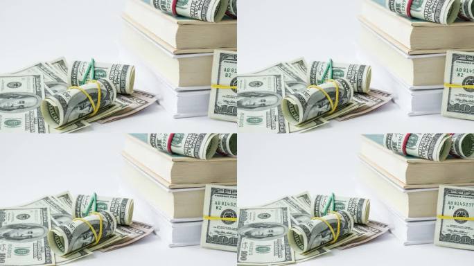 知识带来财富。一堆有美元的书。昂贵教育的概念。钱在书里。为大学攒钱。