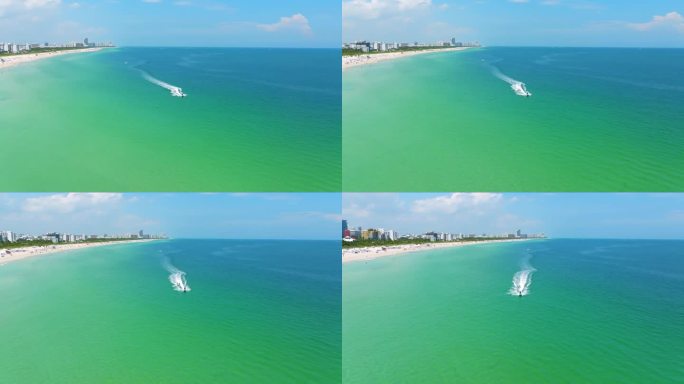 大西洋清澈的海水鸟瞰图，水上摩托车沿着南海滩快速行驶。美丽的风景和放松的迈阿密