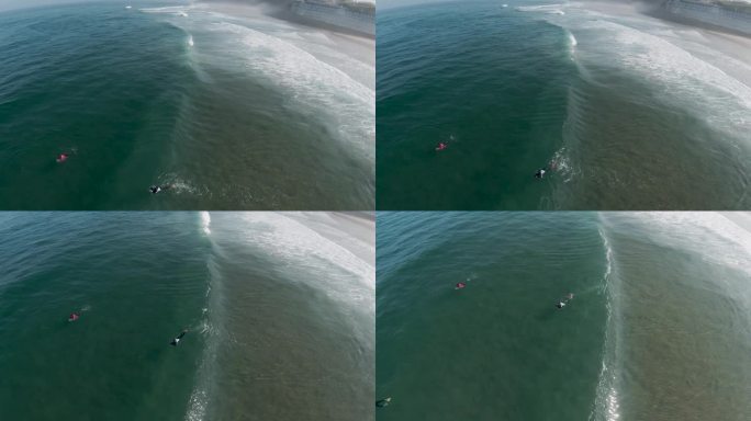 冲浪运动员在清澈的海水中游过汹涌的浪头。