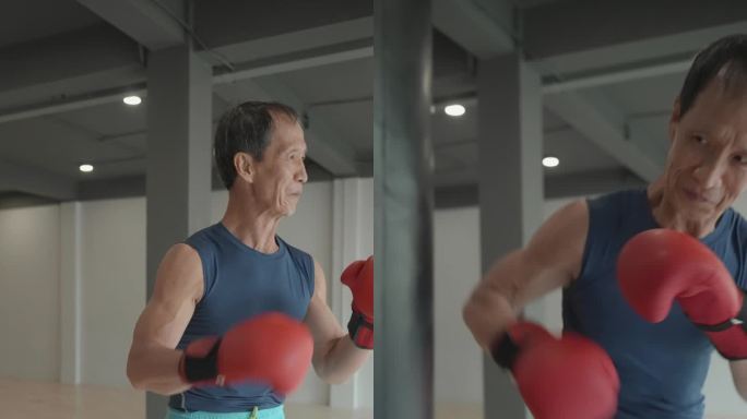 沙袋训练，身穿运动服的亚洲65岁老年肌肉男，在现代健身房拳击沙袋。近距离拍摄一位戴着拳击手套训练的老