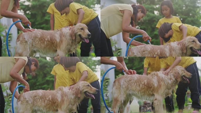 妈妈和女儿在后院给狗狗洗澡。