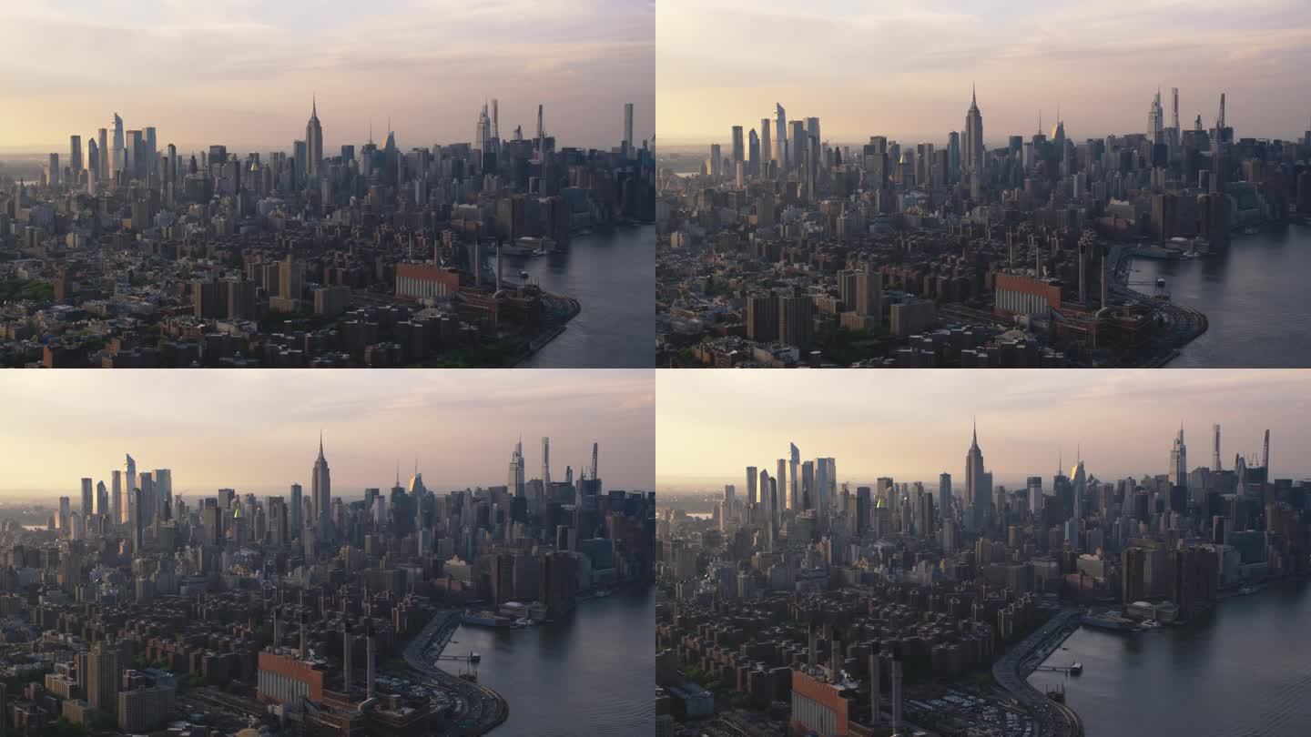 日落时分的纽约天际线。直升机上的曼哈顿航拍画面。东村和东河上的电站电站的全景