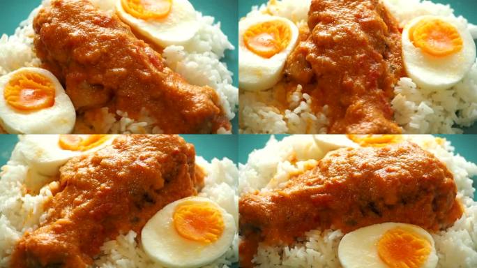 盘子里的咖喱鸡配鸡蛋和米饭