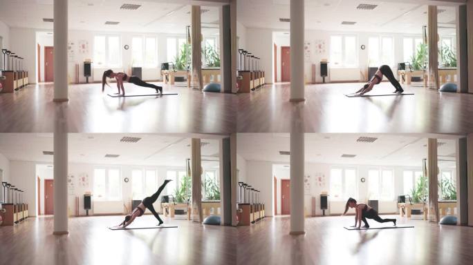 身材苗条的年轻女子穿着运动服，早上在空荡荡的健身房大厅里练习瑜伽。活跃人群生活方式或心理健康概念4K