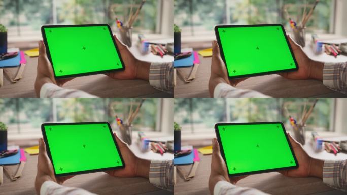 富有创意的黑人手持平板电脑，在绿屏模拟显示的电脑上观看内容。视频模板与艺术设计广告和激励内容占位符