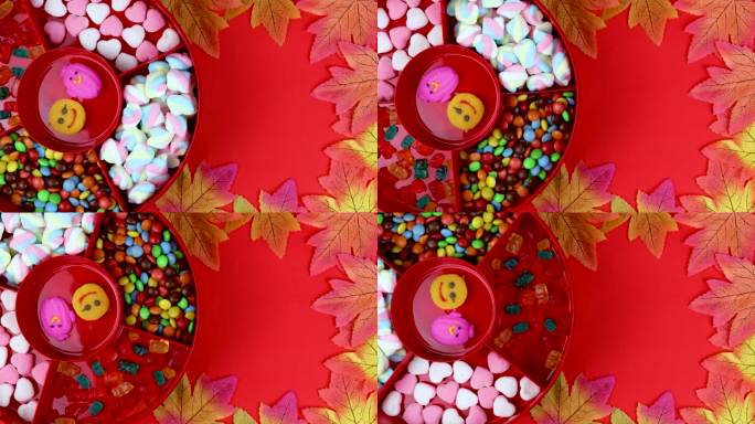 一套不同的美味的糖果在一个红色的糖果盒在红色的背景