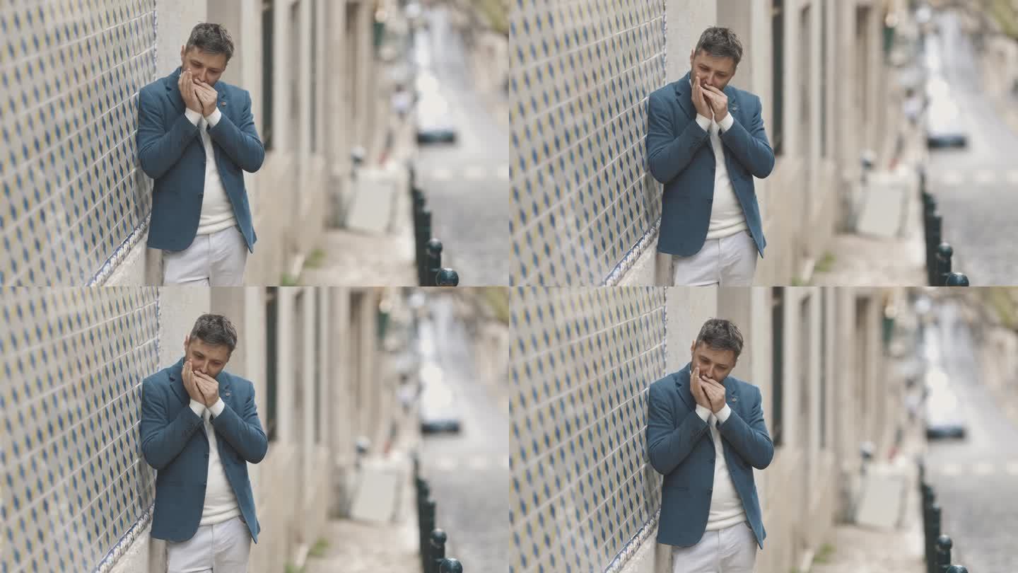 一个穿蓝夹克的人靠墙站在街上吹口琴