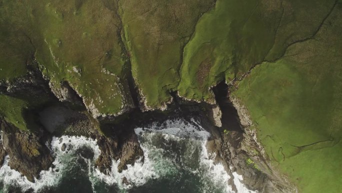 苏格兰天空，海浪冲击着陡峭的海岸绿色悬崖，海雾消散