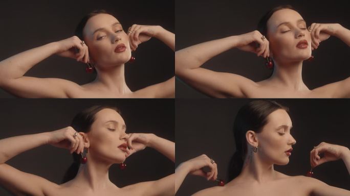 性感的女人与红色的口红黑色背景工作室拍摄摆樱果耳环
