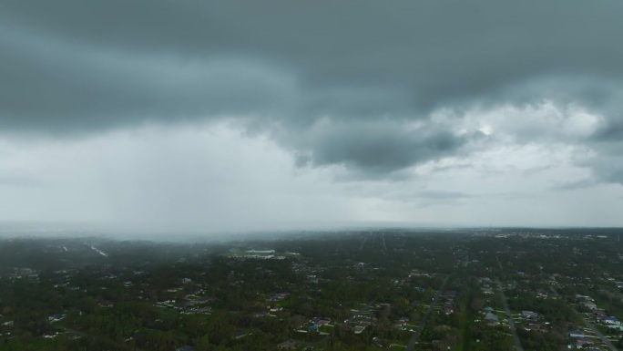 在郊区城镇地区的暴雨中，乌云在阴沉的天空中形成