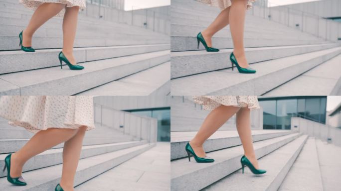 一个不知名的女人穿着裙子和翡翠绿的细高跟鞋走下城市的楼梯