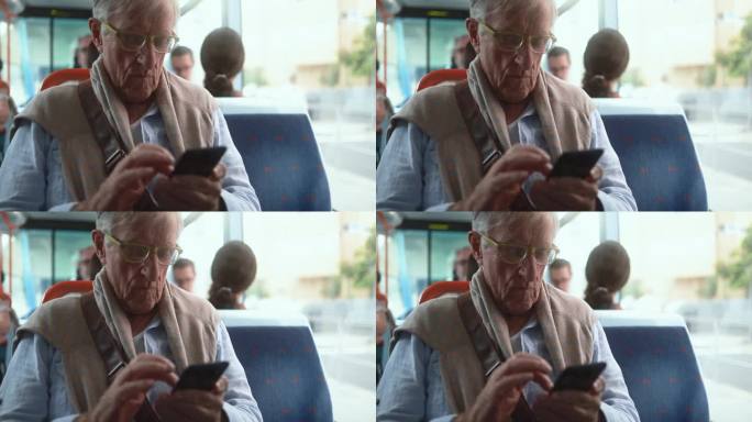 老人坐在电车里玩手机——老年人的生活方式和科技理念
