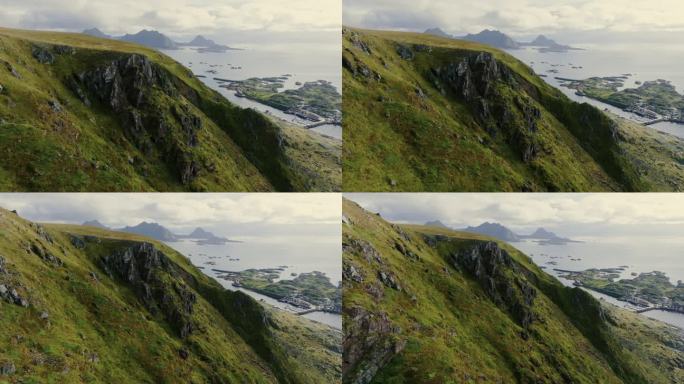 美丽的无人机视图绿色岩石峡湾和挪威小镇的背景。