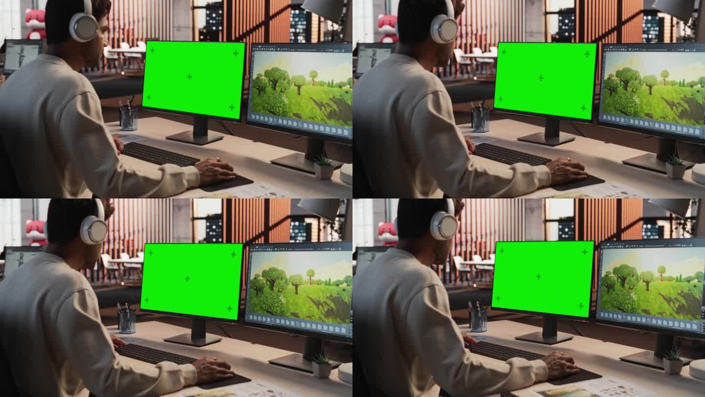 印度男性游戏设计师使用带有绿屏Chromakey的桌面电脑，在RPG视频游戏的3D建模软件中设计沉浸