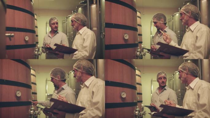 酿酒师在现代工厂生产中检查葡萄酒质量。