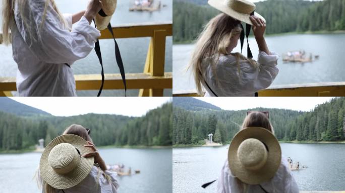 美丽的金发女孩戴着一顶戴着黑丝带的草帽，在一个木筏的背景上看着山上的湖。西尼维尔湖附近的一个女人