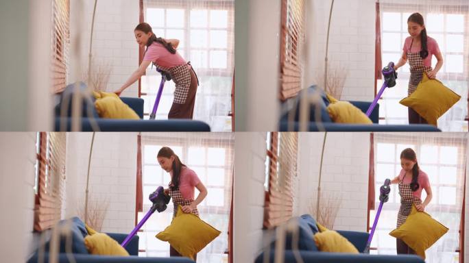 亚洲年轻美女在家里的客厅打扫室内。美丽的女孩家庭主妇管家清洁工感觉快乐，享受吸尘地板为家务或家务在家