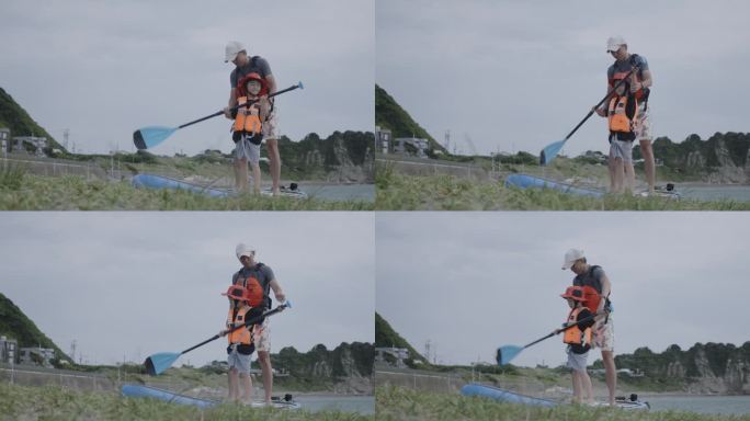 爸爸在宁静的海滩边耐心地教儿子玩桨板