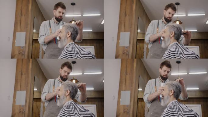 专业理发师使用美发设备为在理发店工作的男性客户梳头