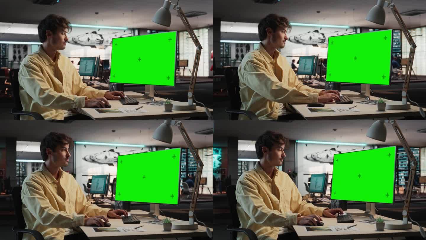白人男子使用桌面电脑模拟绿屏Chromakey。在游戏设计公司工作的男性概念美工，为新的生存电子游戏