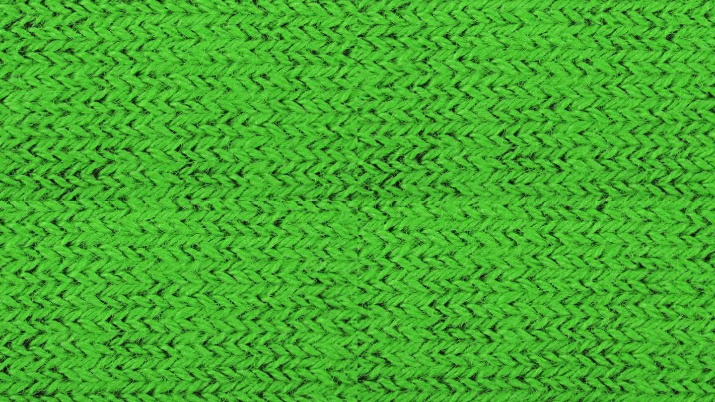 绿色纹理织物布料特写，纺织品背景。从右到左的运动。