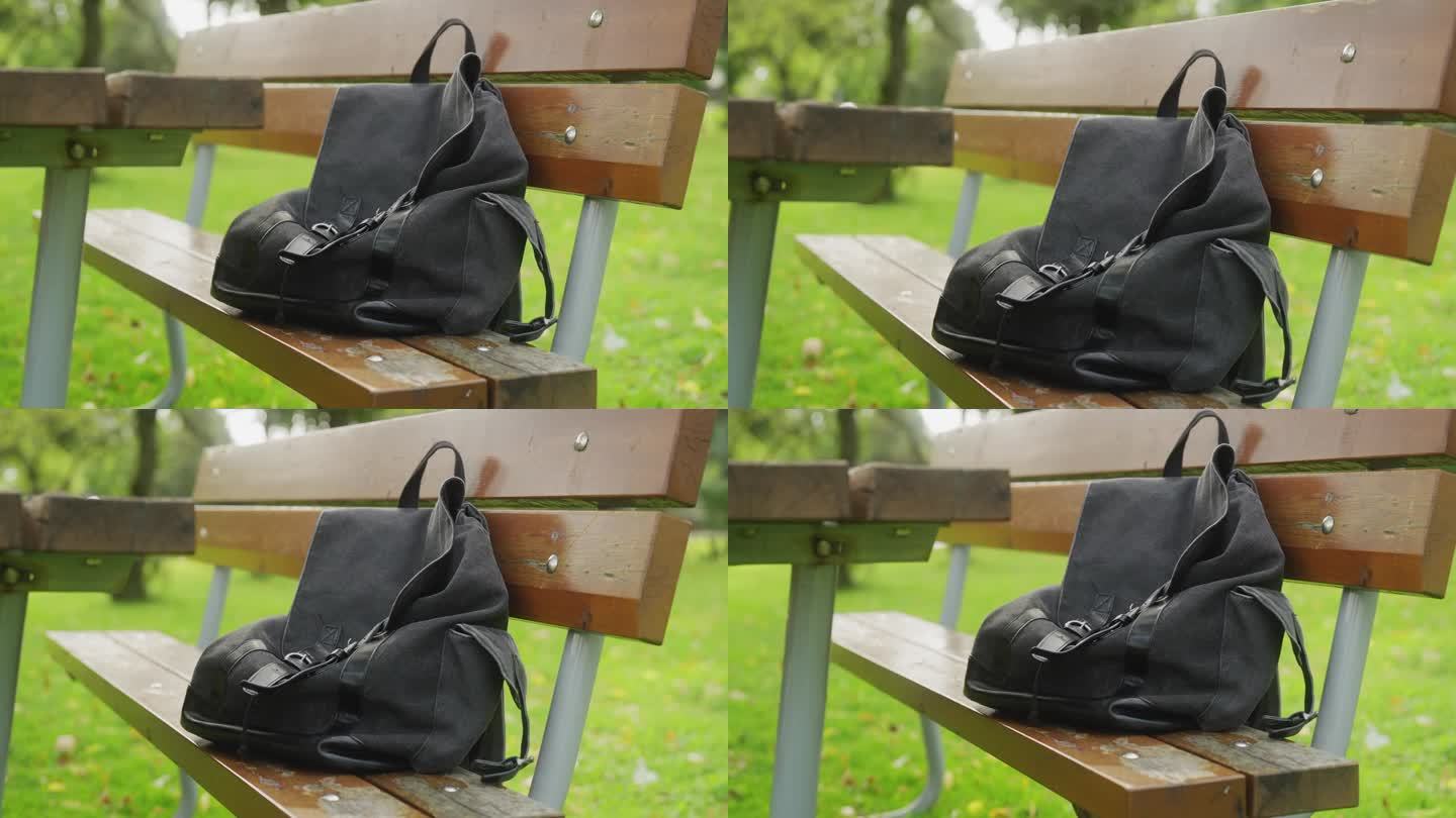 野餐桌旁的长凳上有一个背包