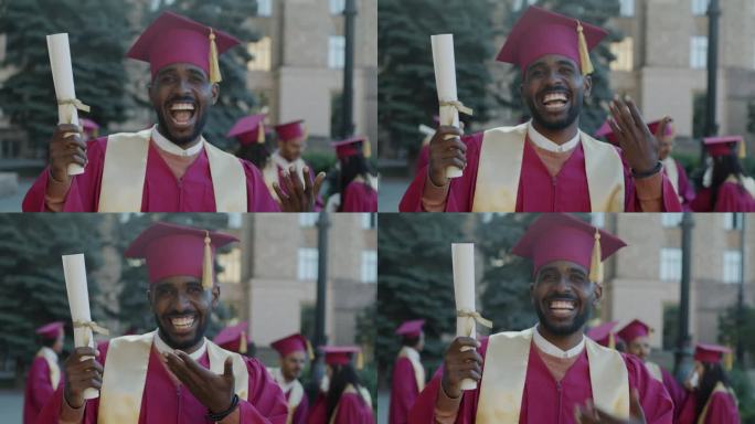 兴奋的非洲裔美国人指着文凭笑着享受大学毕业的日子