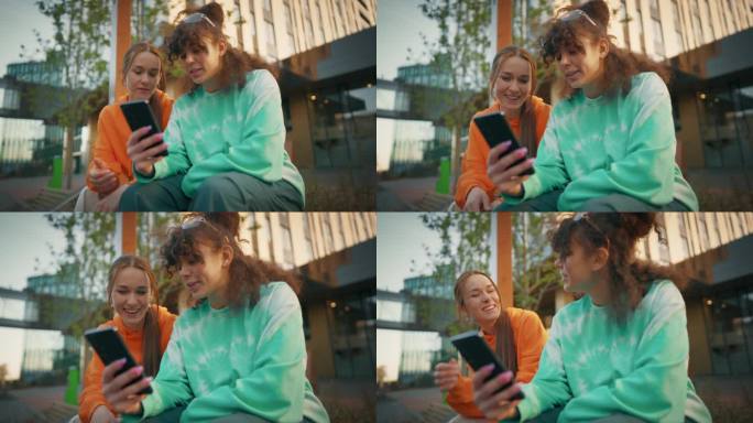两个年轻时尚的女学生在城市街道上聊天，用智能手机浏览社交媒体帖子。两个时髦的女人在市中心外面讨论时尚