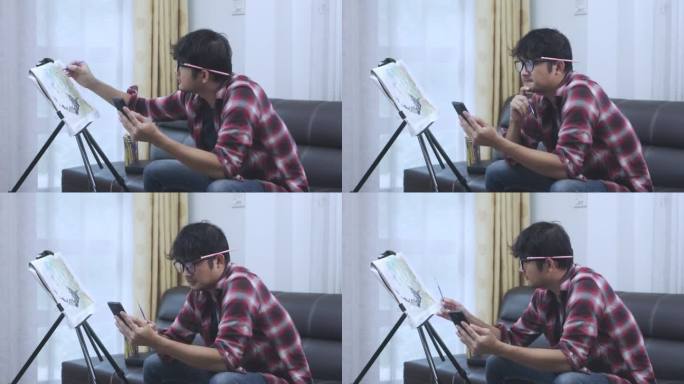 亚洲年轻人以手机图片为范本，在家中创作油画彩水。