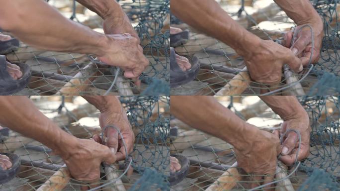 渔夫用手把网修理或固定在一根棍子上以捕鱼