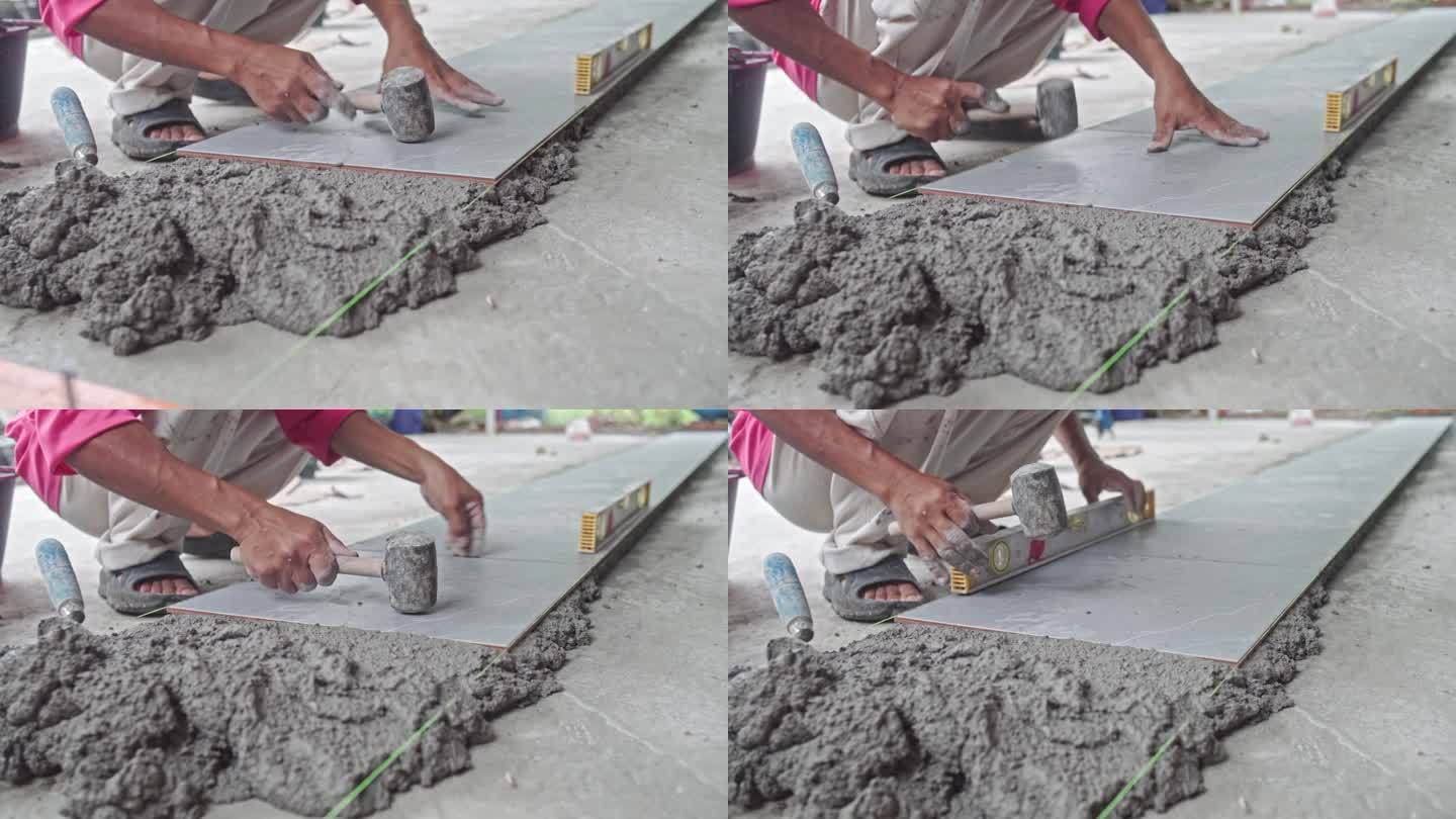 在建筑工地将瓷砖铺在液体水泥上，家装服务行业理念。