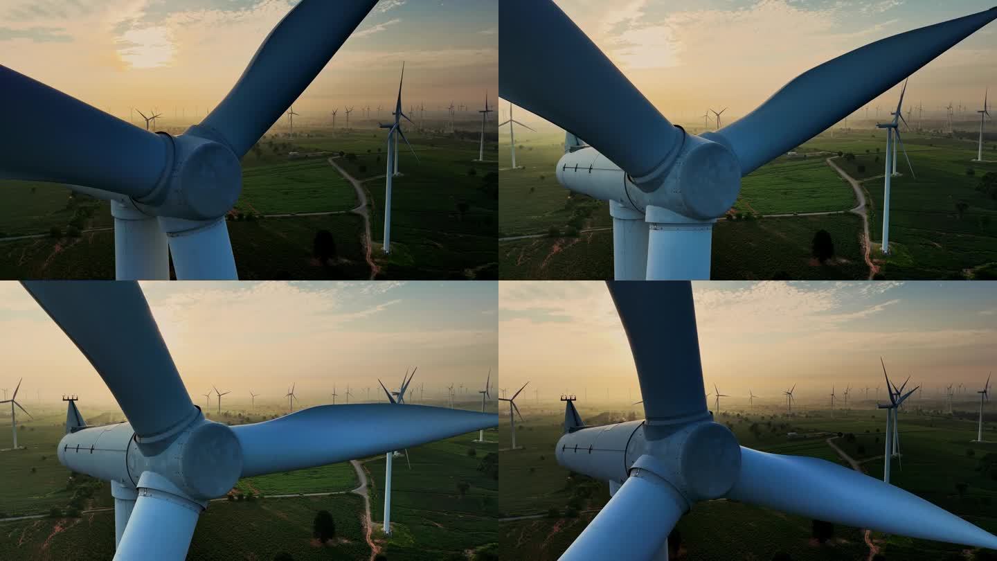 日落时风力涡轮机的航拍照片。