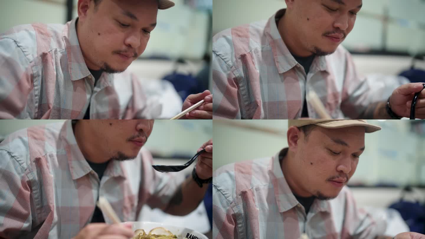 亚洲男子在日本餐厅吃拉面。