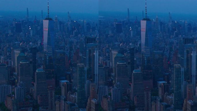 垂直屏幕:曼哈顿下城建筑的晚景鸟瞰图。金融区全景镜头从直升机。哈德逊河和东河水运附近的办公楼