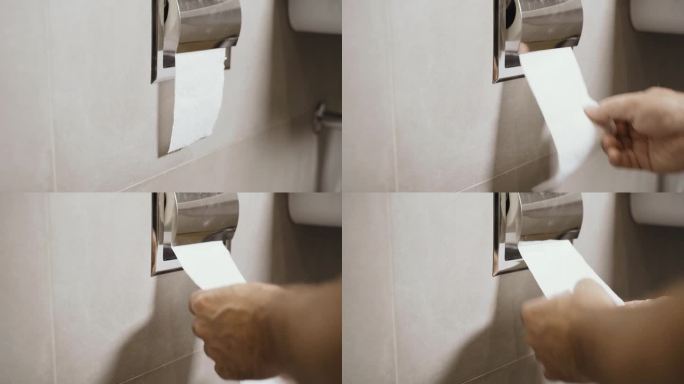 男性松开双手，撕下一张长长的厕纸。