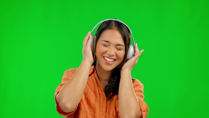 音乐耳机，快乐和女人在绿色屏幕上的工作室隔离的背景模型。电台，收听和亚洲人流媒体音频，声音或爵士播客