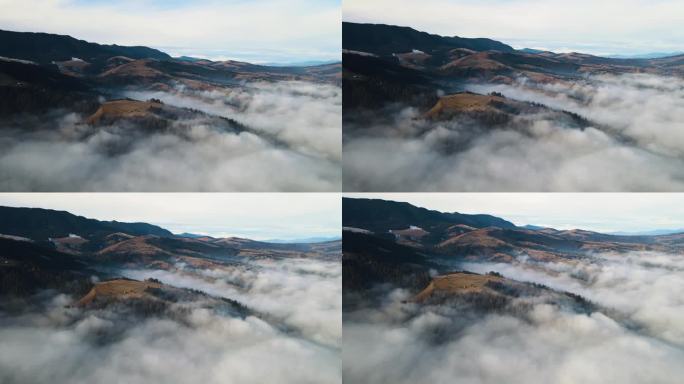 飞过山顶的云层。山峰高耸，清晨日出，自然景观优美