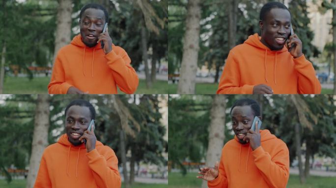 快乐的非裔美国学生在城市外用手机说话，微笑着享受谈话