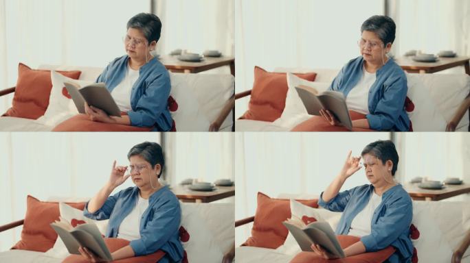 平静与安详:亚洲老妇人沉浸在文学中，在她舒适的客厅里寻找孤独