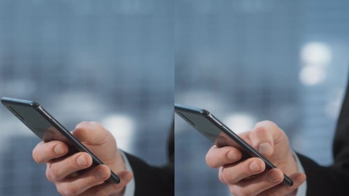 垂直屏幕:白人男性企业家在公司办公室使用智能手机的特写镜头。成功的商人通过电子邮件，安排会议，网上聊