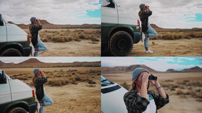 一名妇女用双筒望远镜观察摩洛哥某地的沙漠