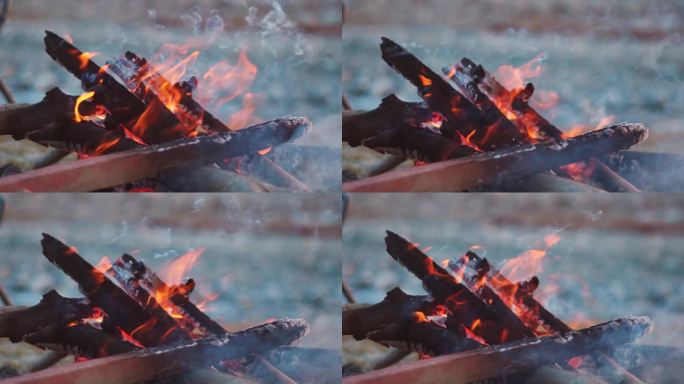 在印度喜马偕尔邦的马纳里，用木头堆成的篝火的特写慢镜头，用来取暖。篝火火焰的特写镜头。由于强烈的寒风