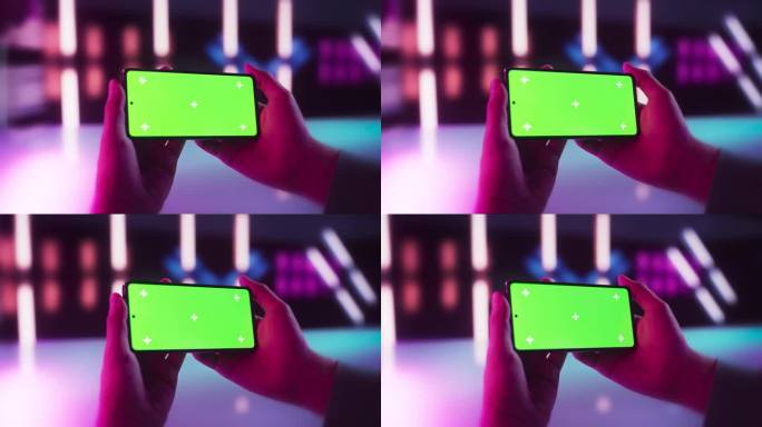 匿名玩家水平手持智能手机，绿屏模拟显示，在线观看视频。数字演示模板，商业内容创建，创意沟通